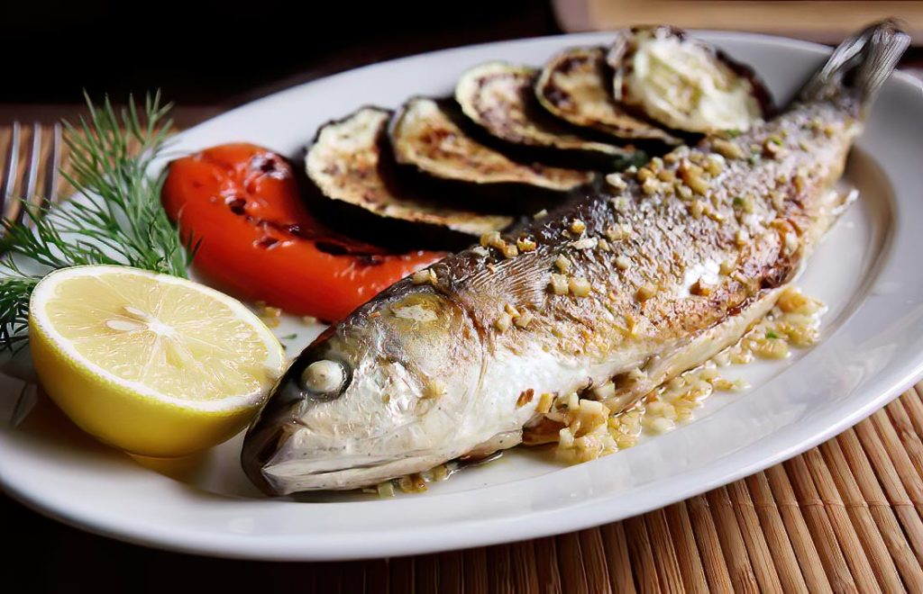 Grilled or Oven-Baked Sea Bass with Garlic, Served with Baked Red Pepper and Eggplant