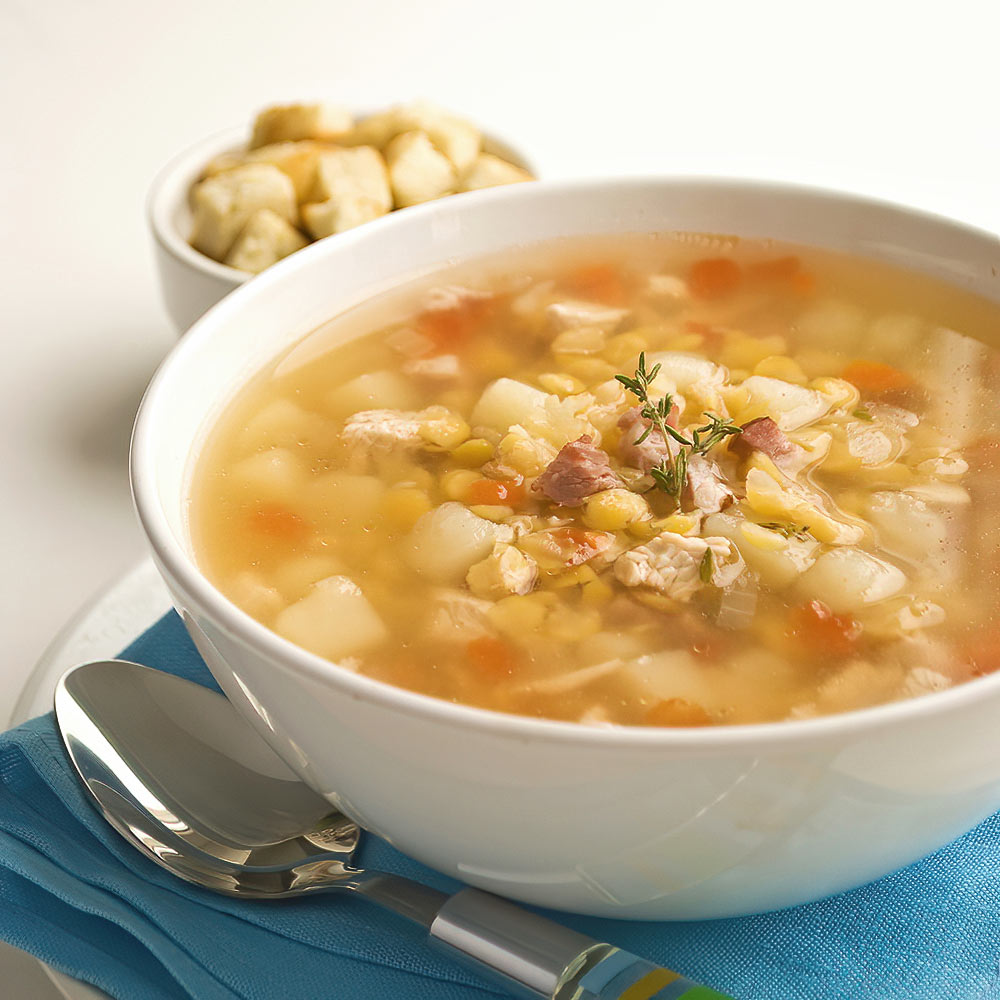 A traditional Slovak pea soup with a light, flavorful broth, enriched with smoked bacon and fresh vegetables.