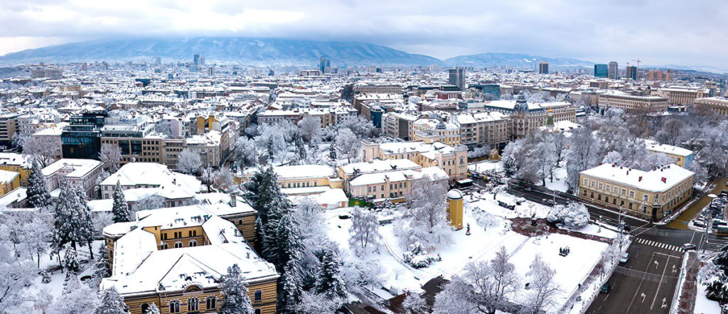 Aerial view of the beautiful Sofia city covered with snow in the cold winter day